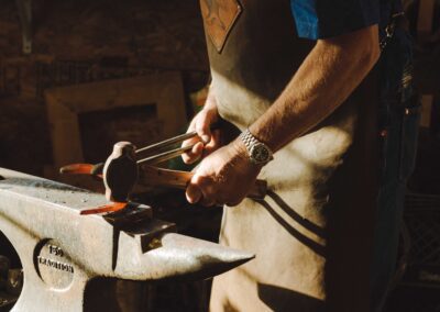 a man is working on an anvil